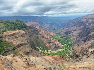 a landscape view of a cliff overlooking a valley