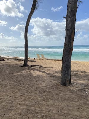two beach chairs in front of tropical ocean