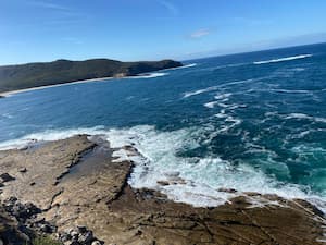 ocean waves lapping at a flat rocky surface