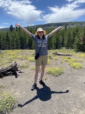 author standing in front of forest landscape
